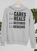 Sudadera Él cuida, Él sana, Él restaura, Él redime